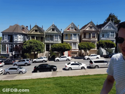 Man In Front Of Colorful Houses GIF