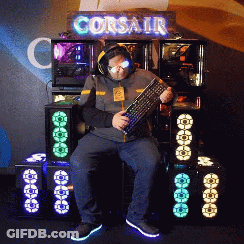 Man In Front Of Corsair Sign Holding Keyboard GIF