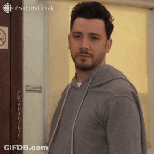 Man In Front Of Door With No Smoking Sign GIF