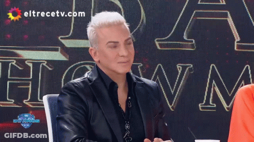 Man In Front Of Eltrecetv.com Sign GIF