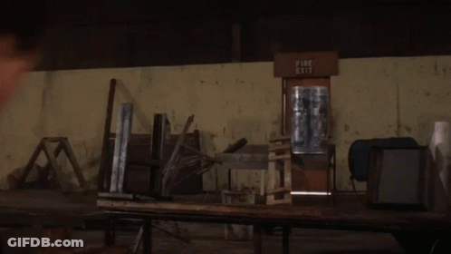Man In Front Of Fire Exit Sign GIF