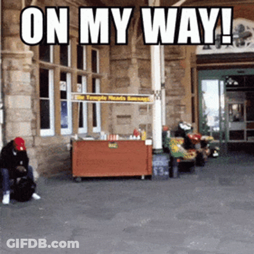 Man In Front Of Food Stand Saying On My Way GIF