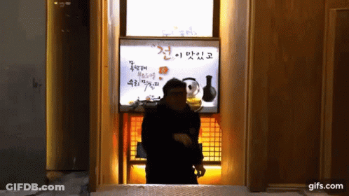 Man In Front Of Gifs.Com Sign GIF