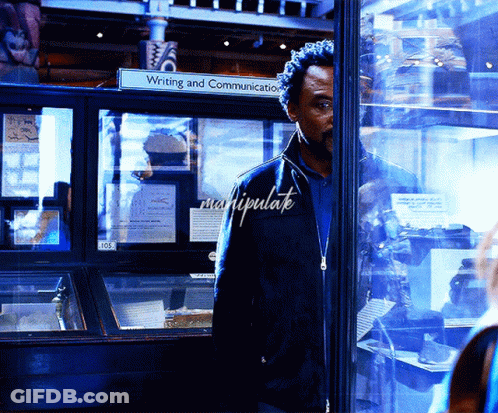 Man In Front Of Glass Display Case Saying Writing And Communication GIF