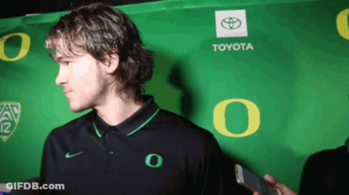 Man In Front Of Green Toyota Sign GIF