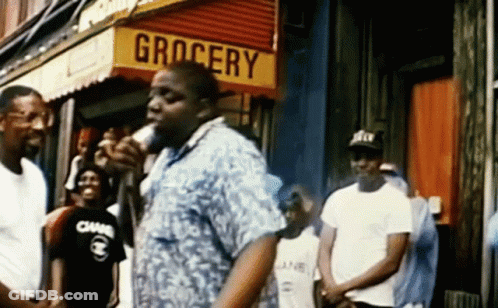 Man In Front Of Grocery Store Holding Microphone GIF