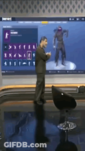 Man In Front Of Large Screen With Ninja GIF