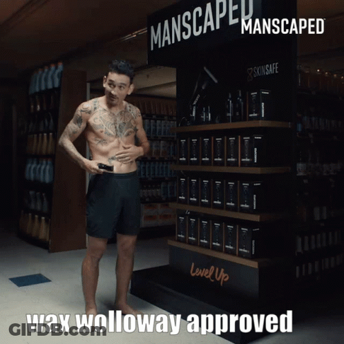 Man In Front Of Manscaped Sign GIF