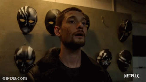 Man In Front Of Mask Wall With Netflix GIF