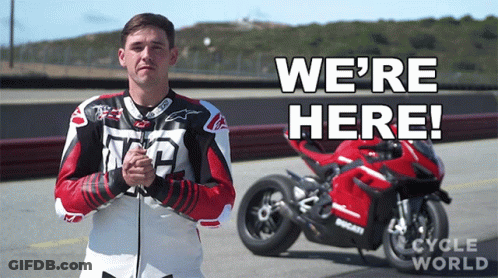 Man In Front Of Motorcycle Saying We're Here GIF