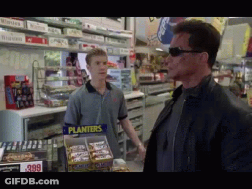 Man In Front Of Planters Candy Display GIF