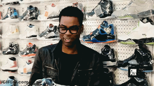 Man In Front Of Shoe Wall With Complex Sign GIF