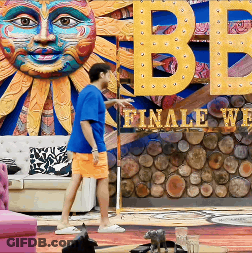 Man In Front Of Sign Saying Finale Week GIF
