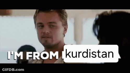Man In Front Of Sign Saying I'm From Kurdistan GIF