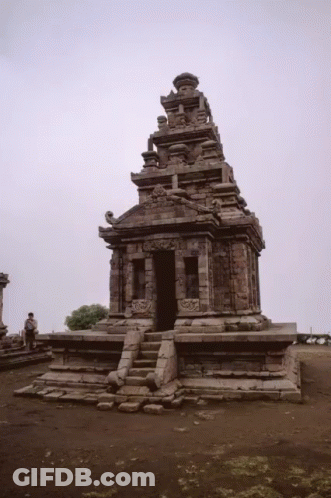 Man In Front Of Stone Temple With Gray Sky GIF