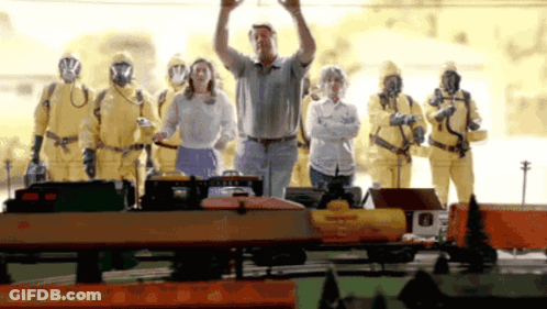 Man In Front Of Train With Yellow Suits GIF