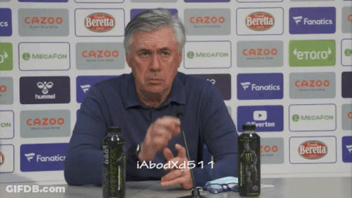 Man In Front Of Wall Of Ads With Cazoo GIF