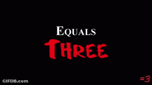 Man In Front Of Wall Saying Equals Three GIF