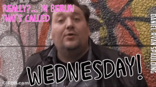 Man In Front Of Wall Saying Wednesday GIF