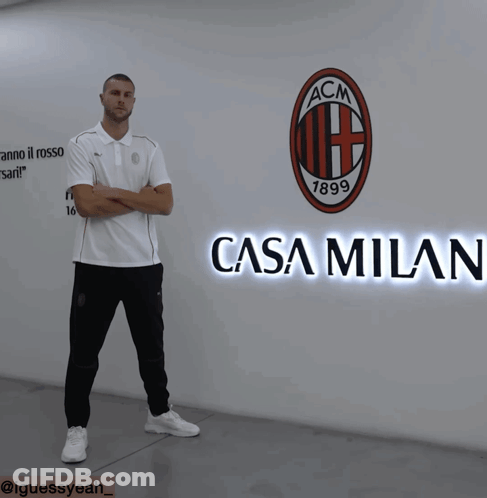 Man In Front Of Wall With ACM Logo GIF