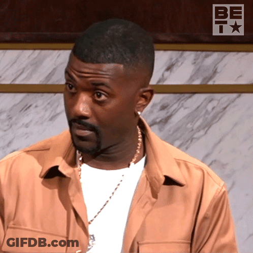 Man In Front Of Wall With Be T Logo GIF