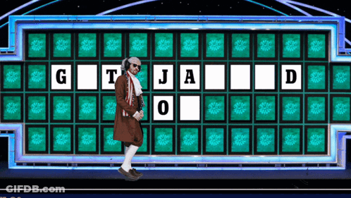Man In Front Of Wheel Of Fortune Board With G T J A O D GIF