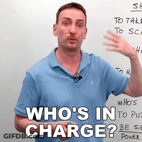 Man In Front Of Whiteboard Saying Who's In Charge GIF
