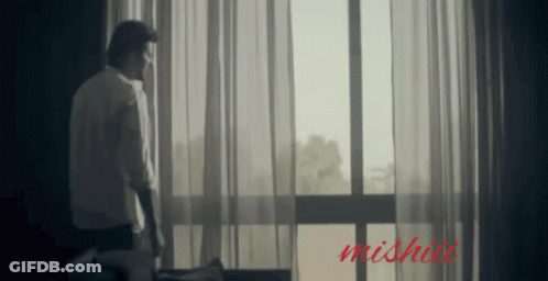 Man In Front Of Window With Word Mishai GIF