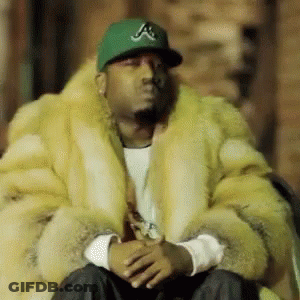 Man In Fur Coat And Green Hat With Letter A GIF