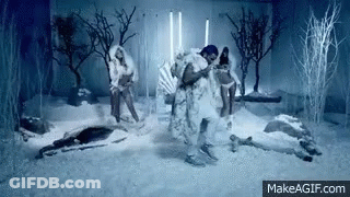 Man In Fur Coat Dancing In Snow With Two Women GIF