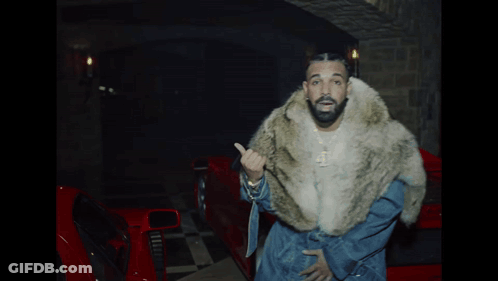 Man In Fur Coat In Front Of Red Car GIF