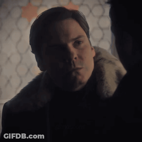 Man In Fur Coat Looking At Another Man GIF