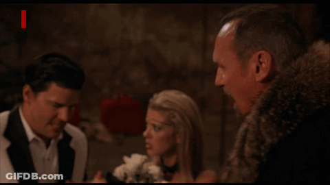 Man In Fur Coat Next To Woman And Man In Suit With Devil And Red Letters GIF