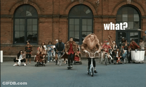 Man In Fur Coat Riding Bike Saying What GIF