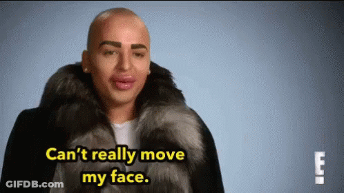 Man In Fur Coat Saying Can't Really Move My Face GIF