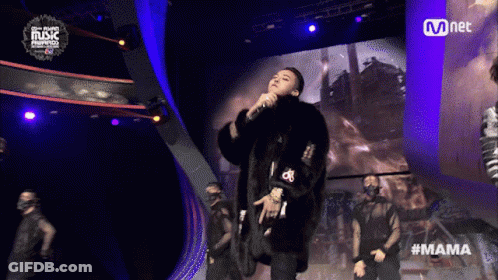 Man In Fur Coat Singing Into Microphone At Mnet Event GIF