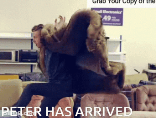 Man In Fur Coat Sitting On Couch Peter Has Arrived GIF