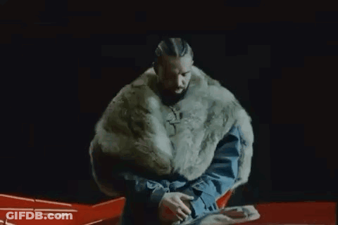 Man In Fur Coat Sitting On Red Car GIF