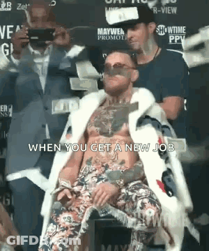 Man In Fur Coat Sitting With Money GIF