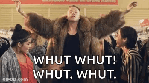 Man In Fur Coat Standing Before Two Women In Store GIF