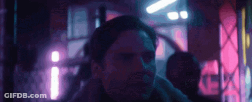Man In Fur Collared Jacket Holding Blue Object GIF