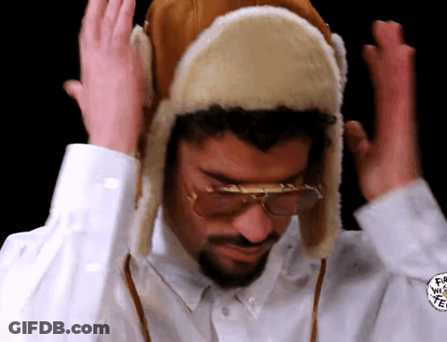 Man In Furry Hat And Glasses Making Funny Face GIF