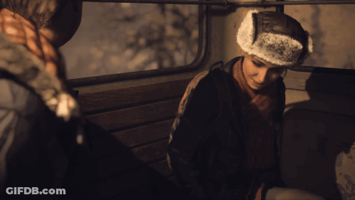 Man In Furry Hat Sitting In Dark Room GIF