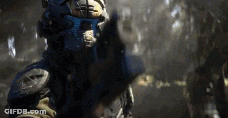 Man In Futuristic Helmet Pointing Gun GIF