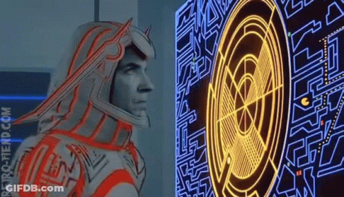 Man In Futuristic Suit Standing In Dark Room With Mem GIF