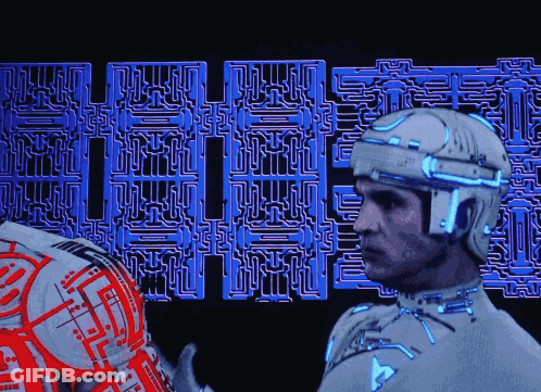 Man In Futuristic Suit Standing In Front Of Maze Saying Eee GIF