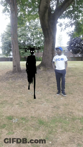 Man In GB Shirt Standing In Front Of Tree GIF
