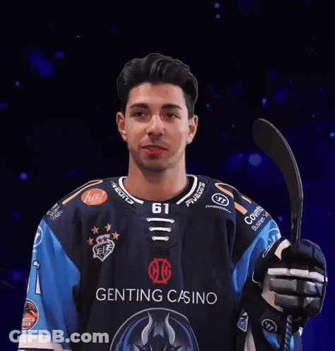 Man In Genting Casino Jersey Holding Hockey Stick GIF