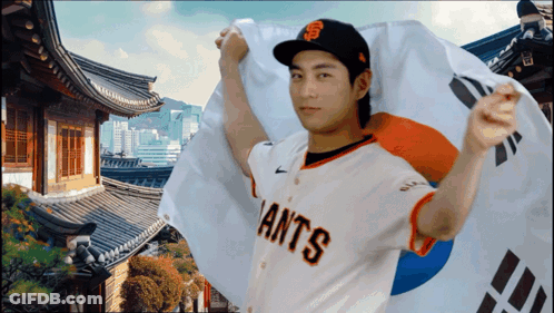 Man In Giants Jersey Holding Korean Flag GIF