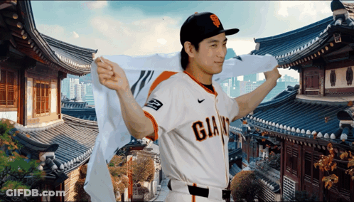 Man In Giants Jersey In Front Of Korean Temple GIF